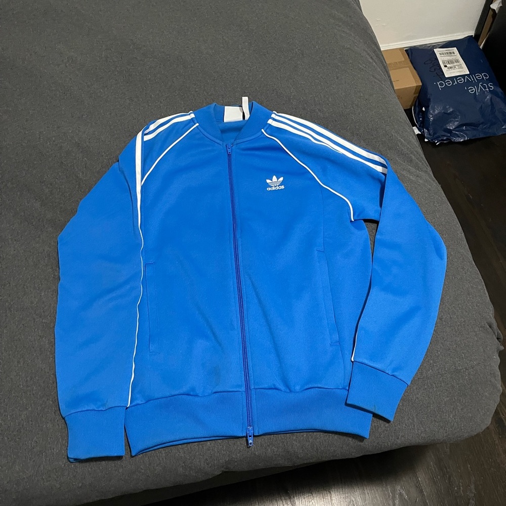 Blue Adidas sports jacket.